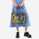 The Shag Exotica Medium Streamline Tote being held by a model