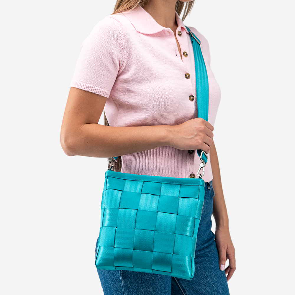 The Mini Messenger in Aqua being worn by a model