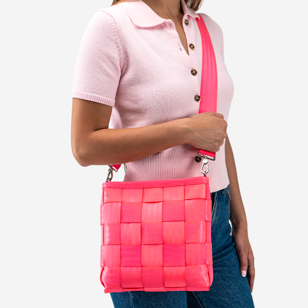 The Mini Messenger in Dragonfruit being worn by a model