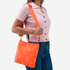 The Mini Messenger in Poppy being worn by a model