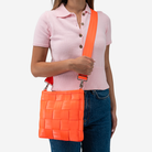 The Mini Messenger in Poppy being worn by a model