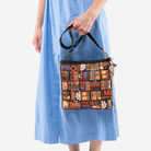 The Shag Tiki Tapa Mini Messenger being held by a model