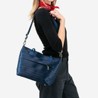 The Indigo Mini Streamline Tote being worn by a model