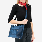 The Indigo Mini Streamline Tote being worn by a model
