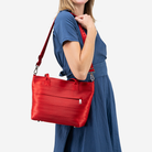 The Mini Streamline Tote in Scarlet being worn by a model