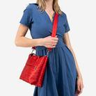The Mini Streamline Tote in Scarlet being worn by a model