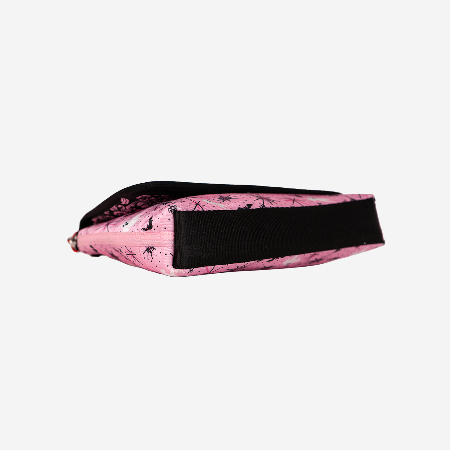 The bottom of a Medium Foldover Crossbody in Pink-A-Boo