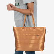 Medium Streamline Tote in the color Cognac on a models arm