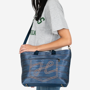 Crossbody view of a Medium Streamline Tote in Denim on a model
