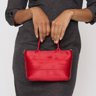 A model wearing the Scarlet Petite Tote
