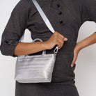 A model wearing the Silver Petite Tote