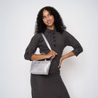 A model wearing the Silver Petite Tote