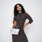 A model wearing the Silver Petite Tote