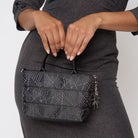 A model wearing a Black Widow Petite Tote