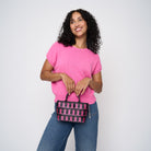 A model wearing The Pink Agenda Pink Ribbon Petite Tote