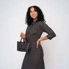 A model wearing a Black Widow Petite Tote