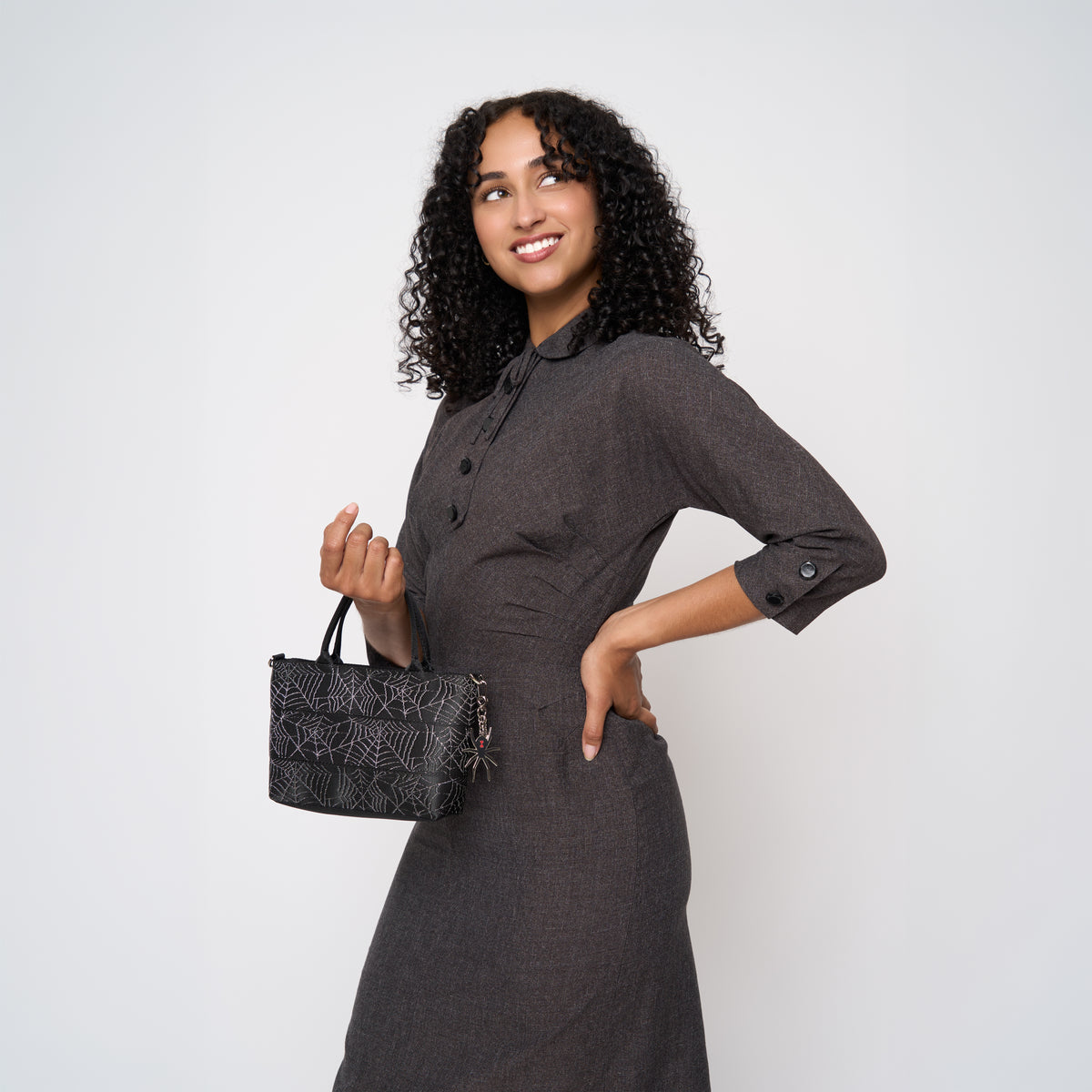 A model wearing a Black Widow Petite Tote