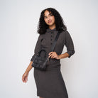 A model wearing a Black Widow Petite Tote