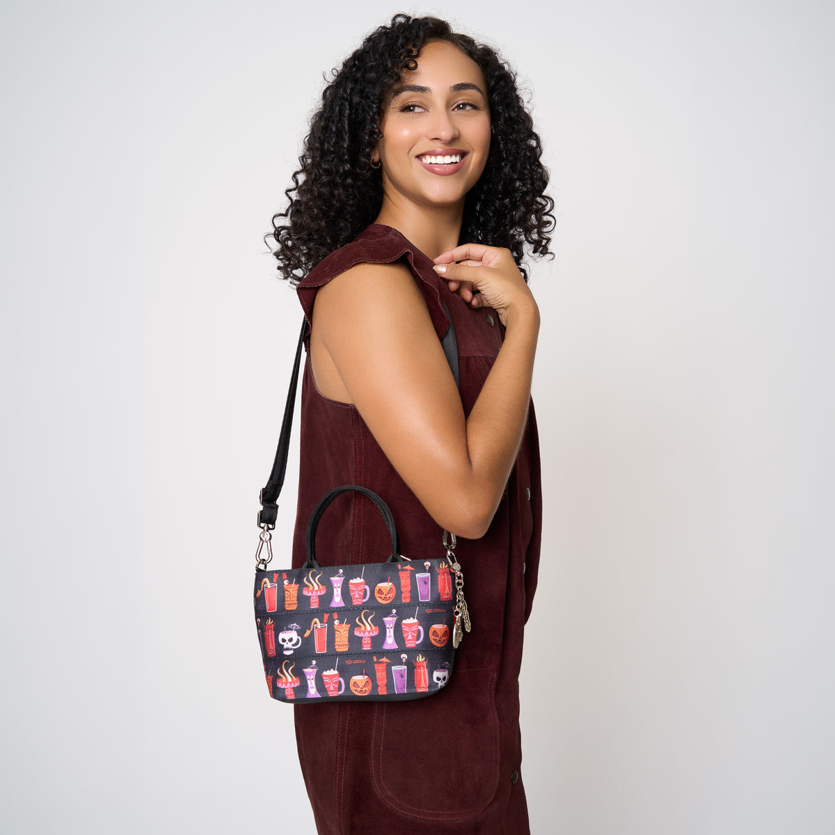 Model wearing petite tote Shag Spooky Tiki Cocktail using extendable shoulder strap