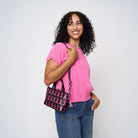 A model wearing The Pink Agenda Pink Ribbon Petite Tote
