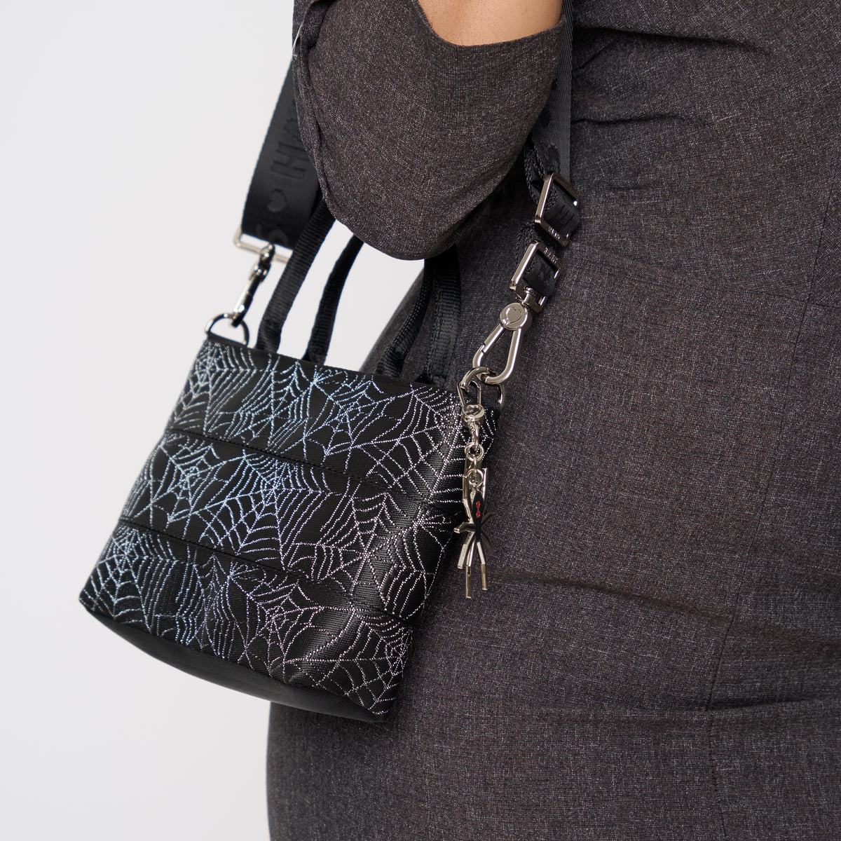 A model wearing a Black Widow Petite Tote