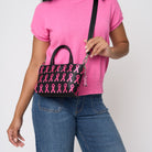 A model wearing The Pink Agenda Pink Ribbon Petite Tote