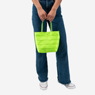 The Rosie Tote in Lime being held by a model
