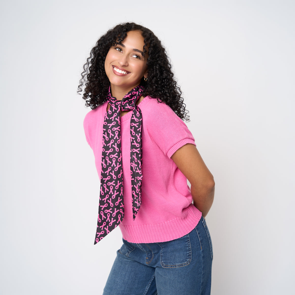 A model wearing The Pink Agenda Pink Ribbon Scarf