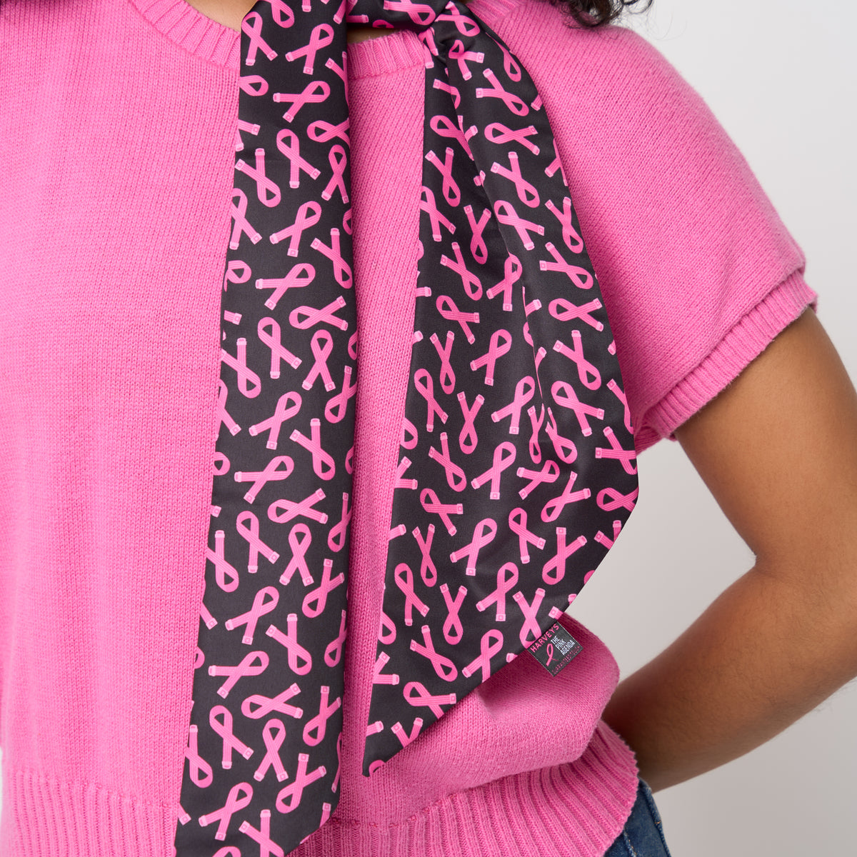 A model wearing The Pink Agenda Pink Ribbon Scarf