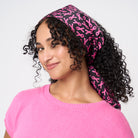 A model wearing The Pink Agenda Pink Ribbon Scarf
