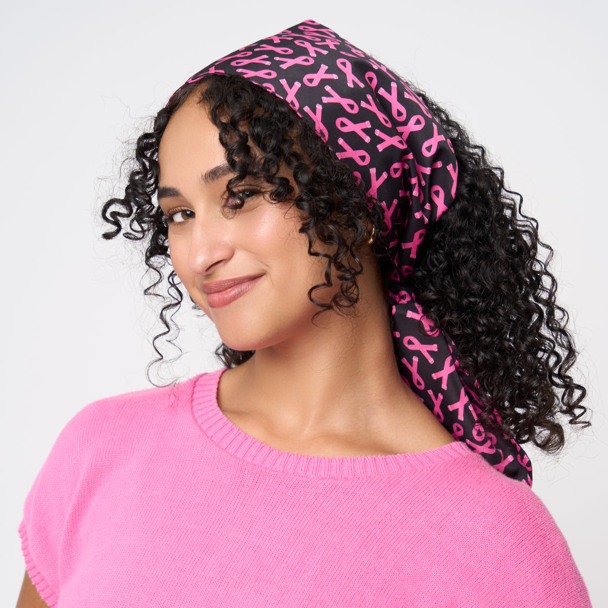 A model wearing The Pink Agenda Pink Ribbon Scarf