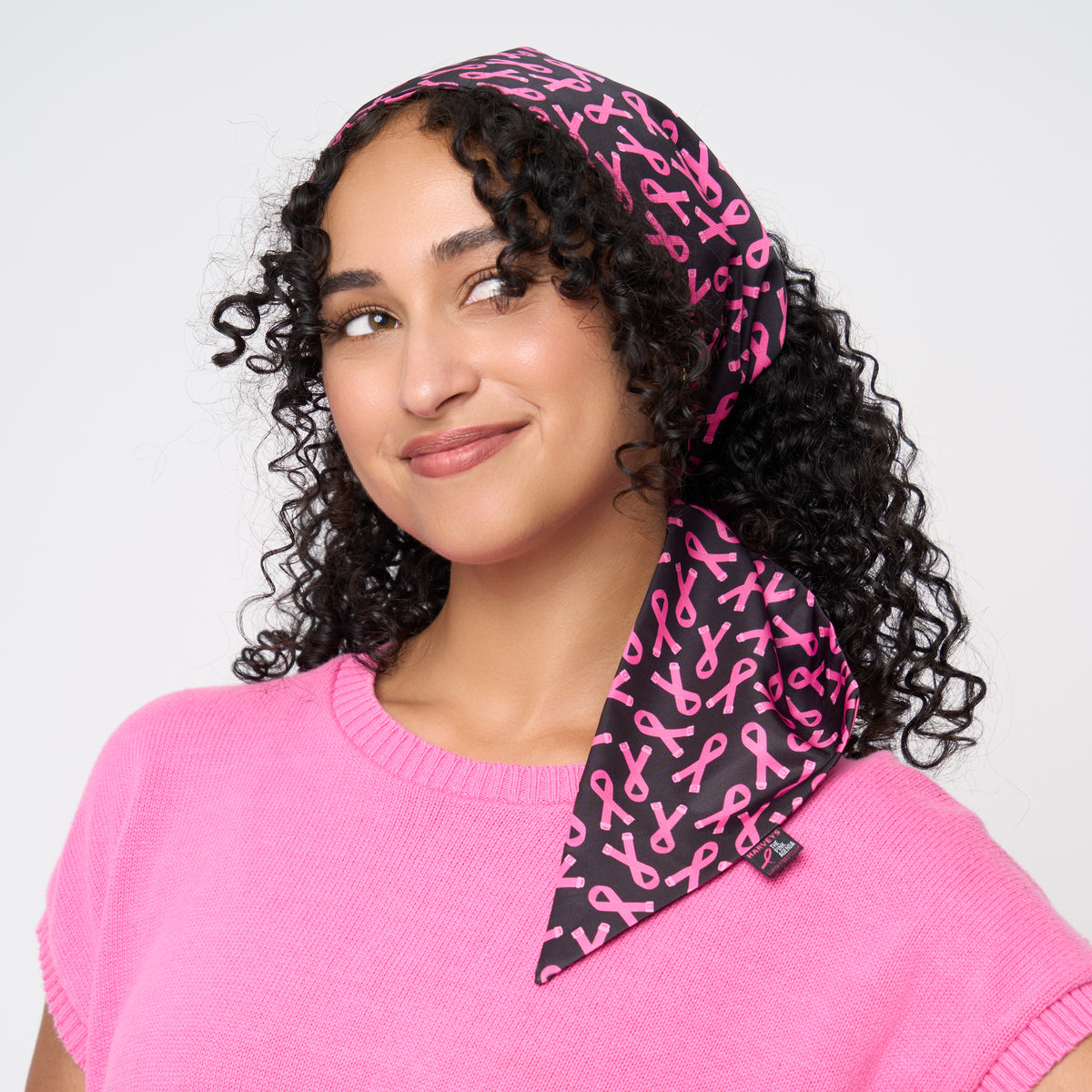 A model wearing The Pink Agenda Pink Ribbon Scarf