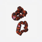 View of small and large scrunchies in orange tartan