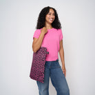 A model wearing The Pink Agenda Pink Ribbon Shopper Tote
