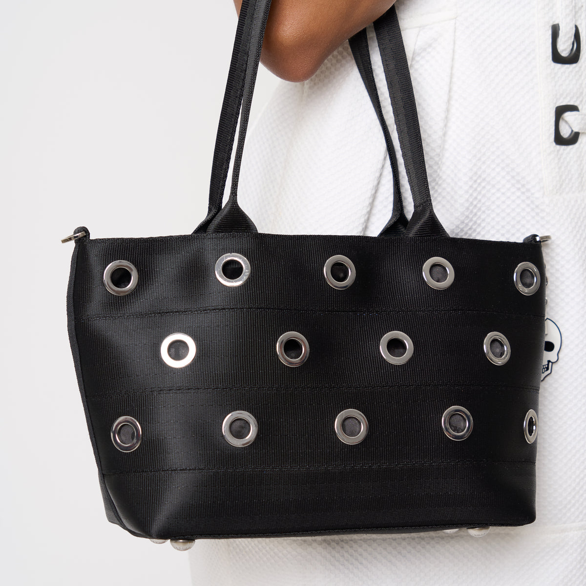 Close up of model carrying PUNK'N streamline baguette grommet on arm