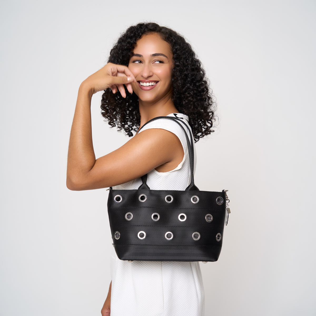 Model holding PUNK'N streamline baguette grommet on shoulder