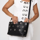 Model carrying PUNK'N streamline baguette grommet using adjustable strap