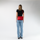 A Scarlet Large Hip Pack being worn crossbody by a model
