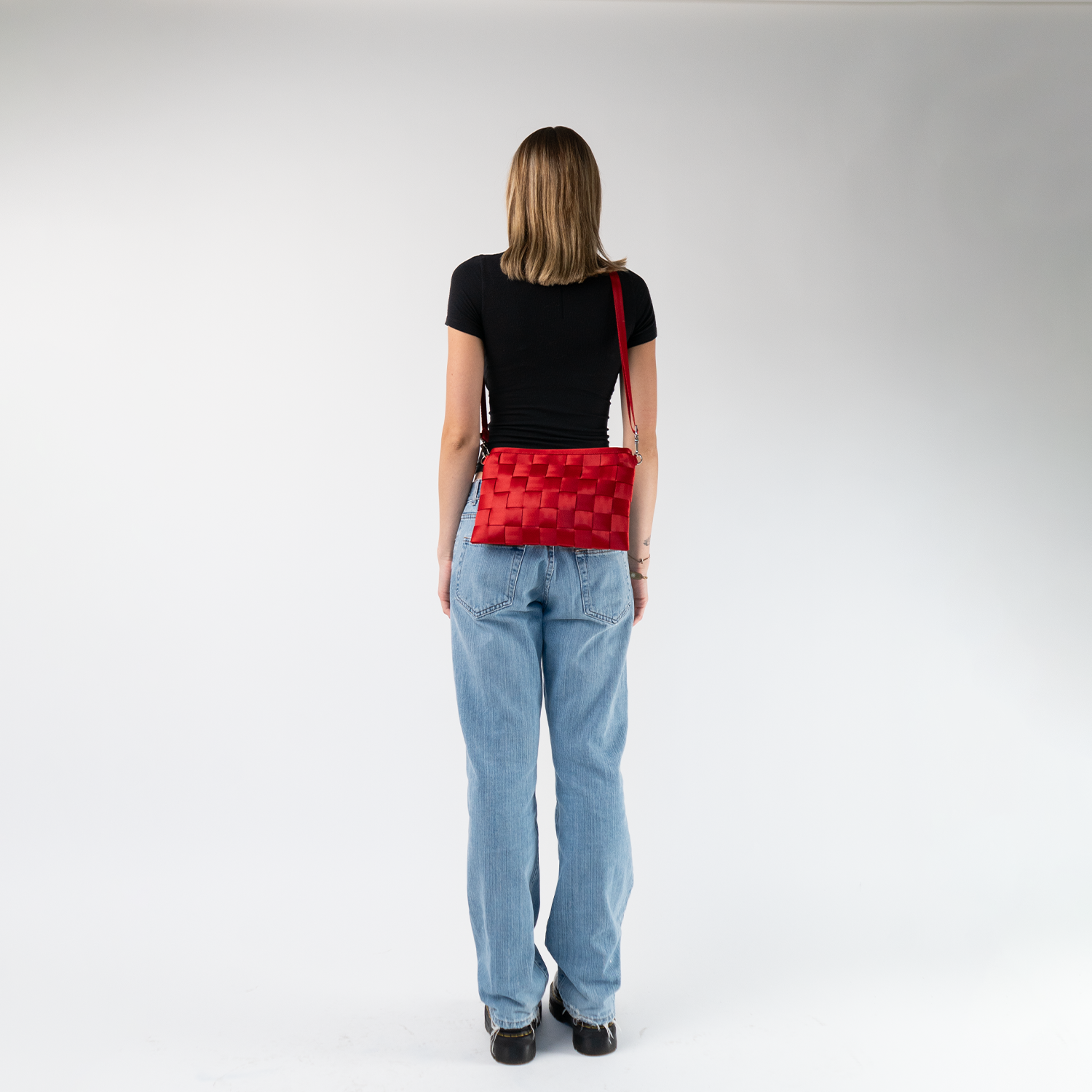 A Scarlet Large Hip Pack being worn crossbody by a model