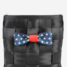 The Seatbelt Bow in Scarlet and Stars being used on a bag