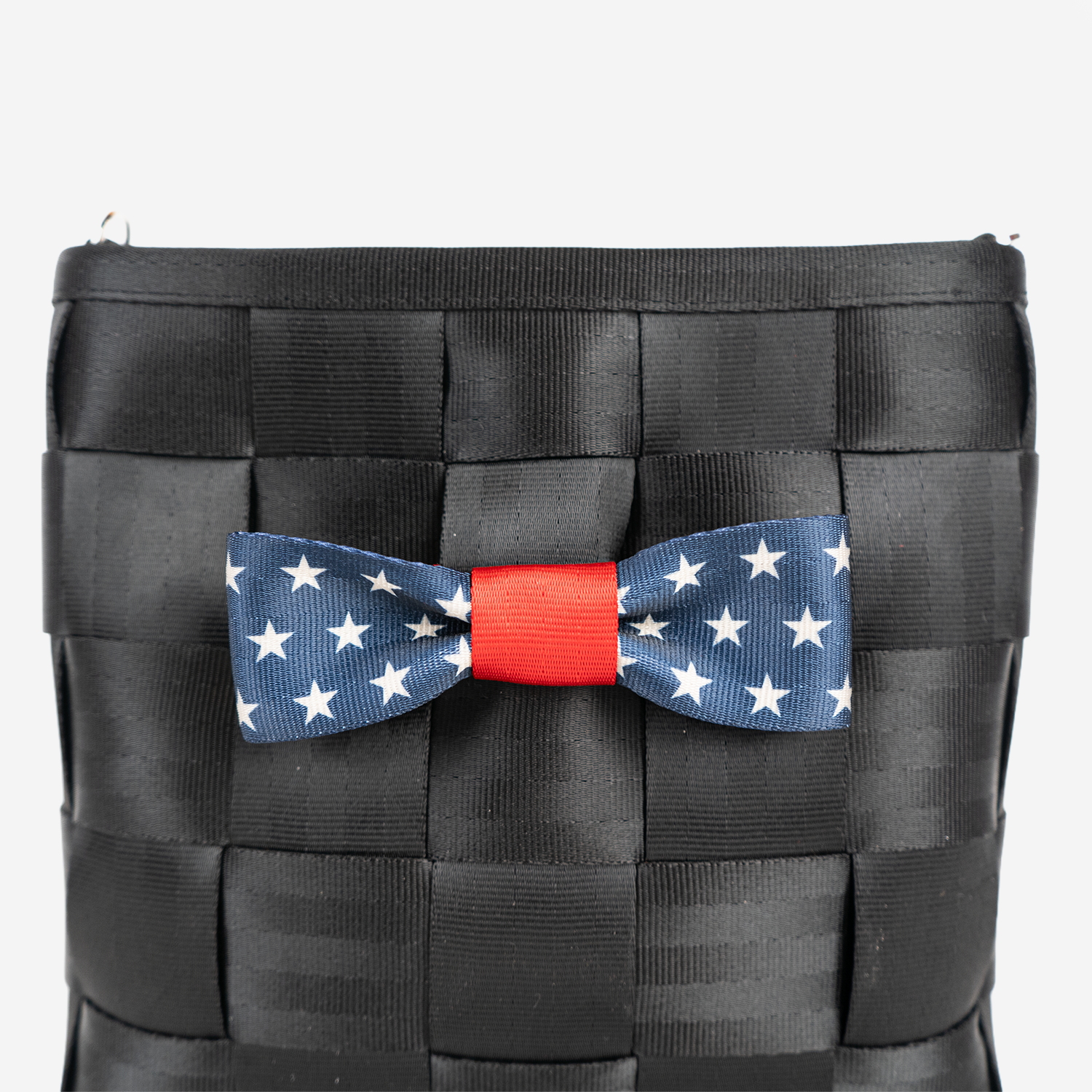 The Seatbelt Bow in Scarlet and Stars being used on a bag