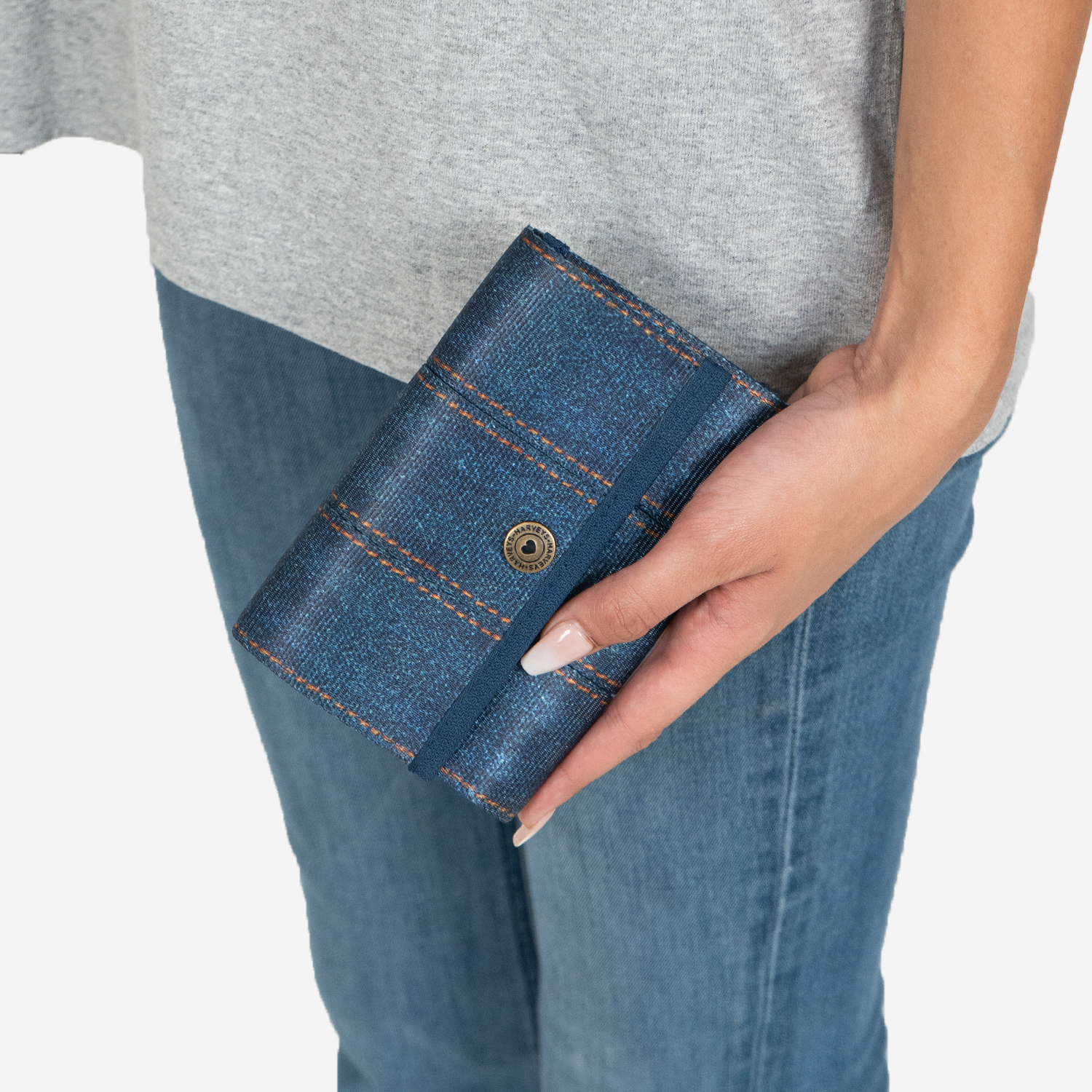 A Snap Wallet in Denim in a models hand