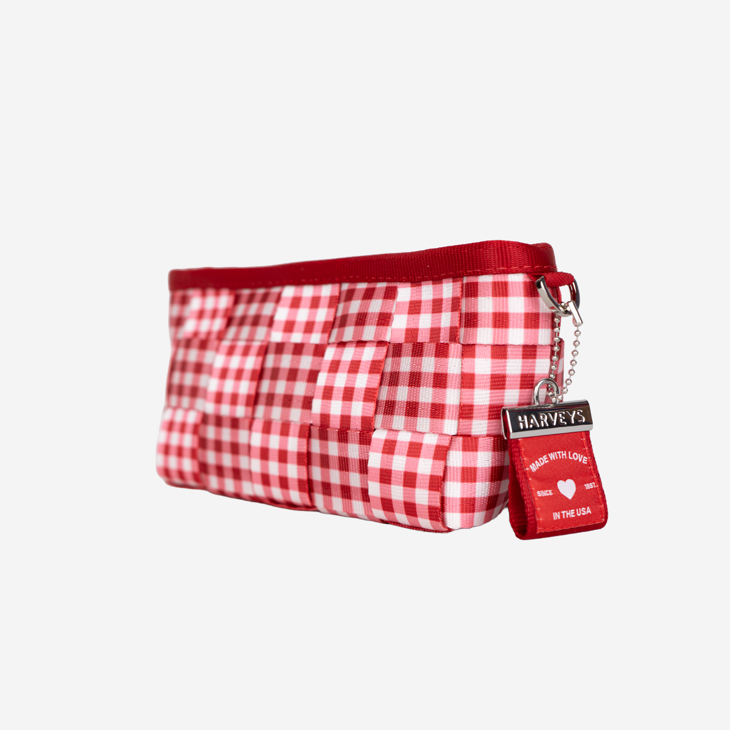The side of a Triangle Makeup Case in Red Gingham