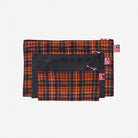 View of 3 sizes of Zip N' Go Pouches in orange tartan & skulls