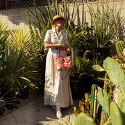 The Betty Rose Mini Streamline Tote being worn by a model