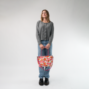 The Betty Rose Mini Streamline Tote being held in a model's hands