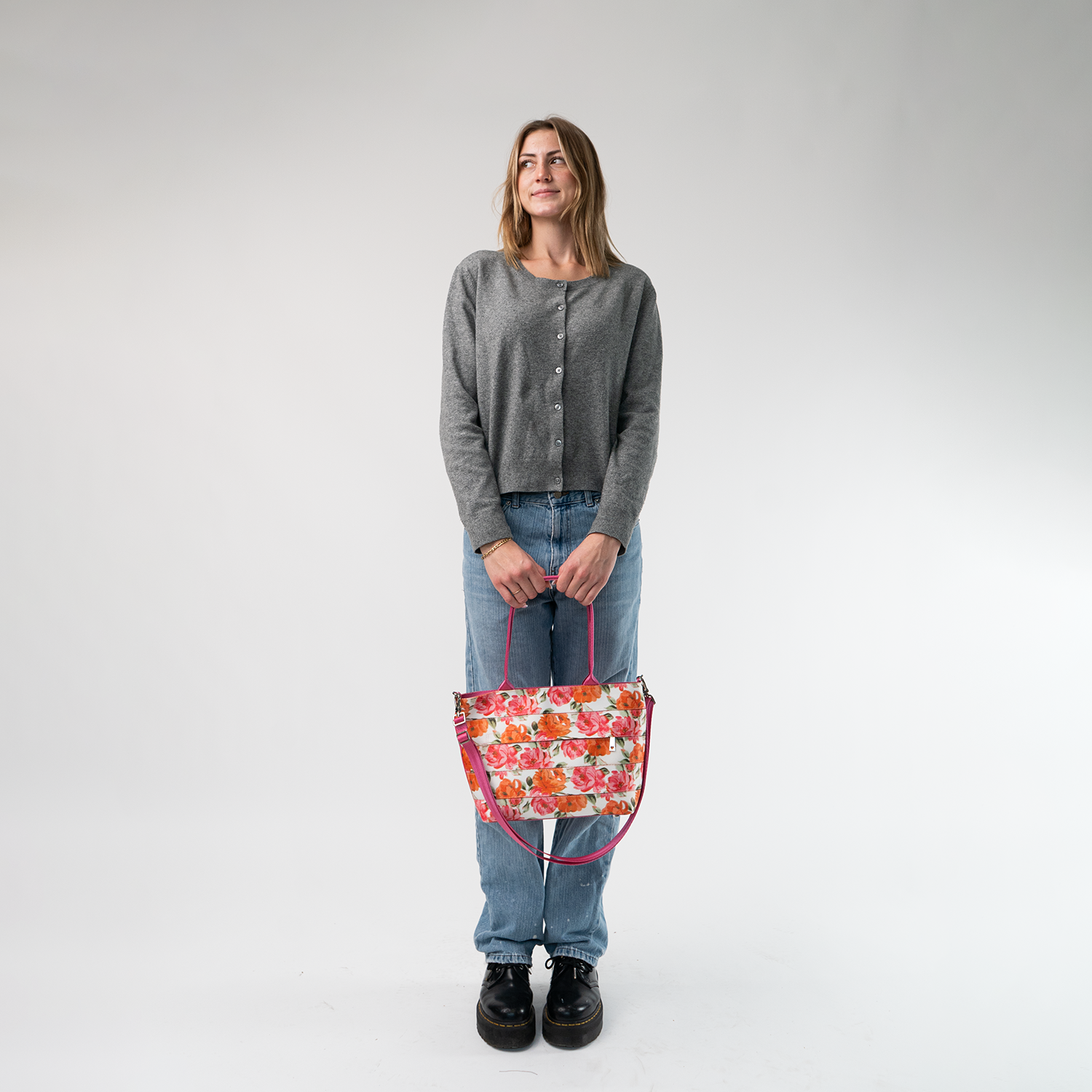 The Betty Rose Mini Streamline Tote being held in a model's hands