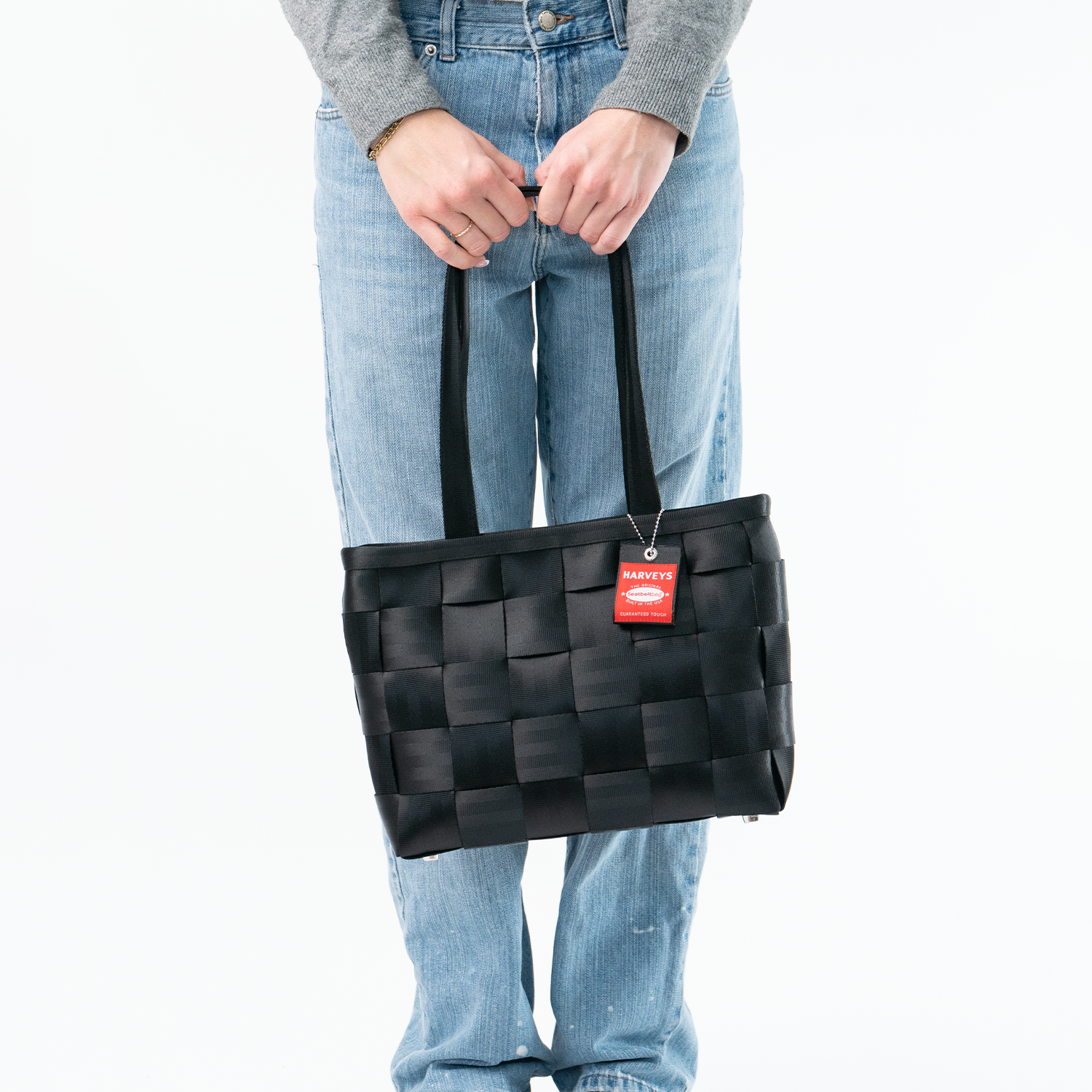 A Large Tote in Black in a model's hands