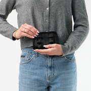 The Black Lola Fun Size Wallet being held in a model's hands