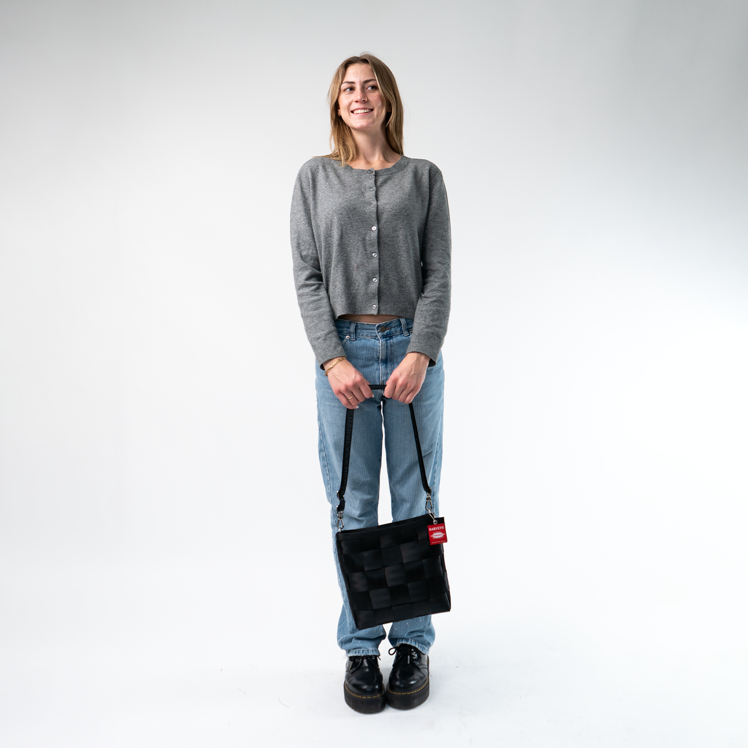 A Mini Messenger in Black in a model's hands